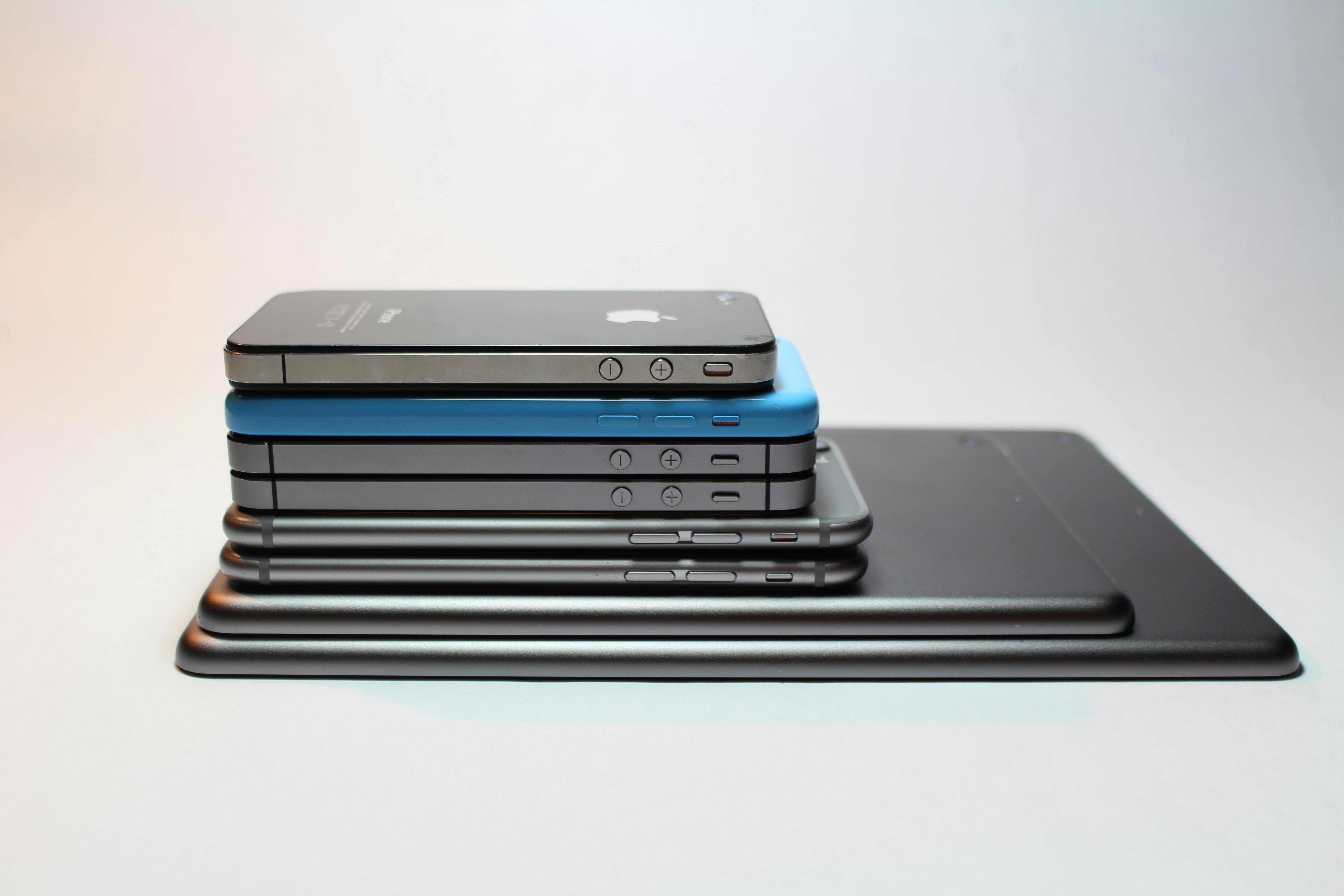 Stack of salvaged smartphones and tablets ready for grading